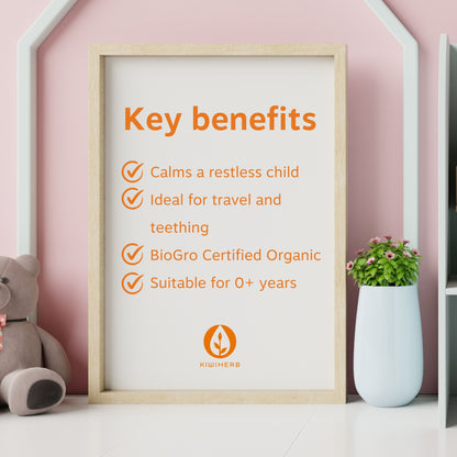 A wooden photo frame in a child's bedroom listing the main benefits of Organic Kid's Calm.