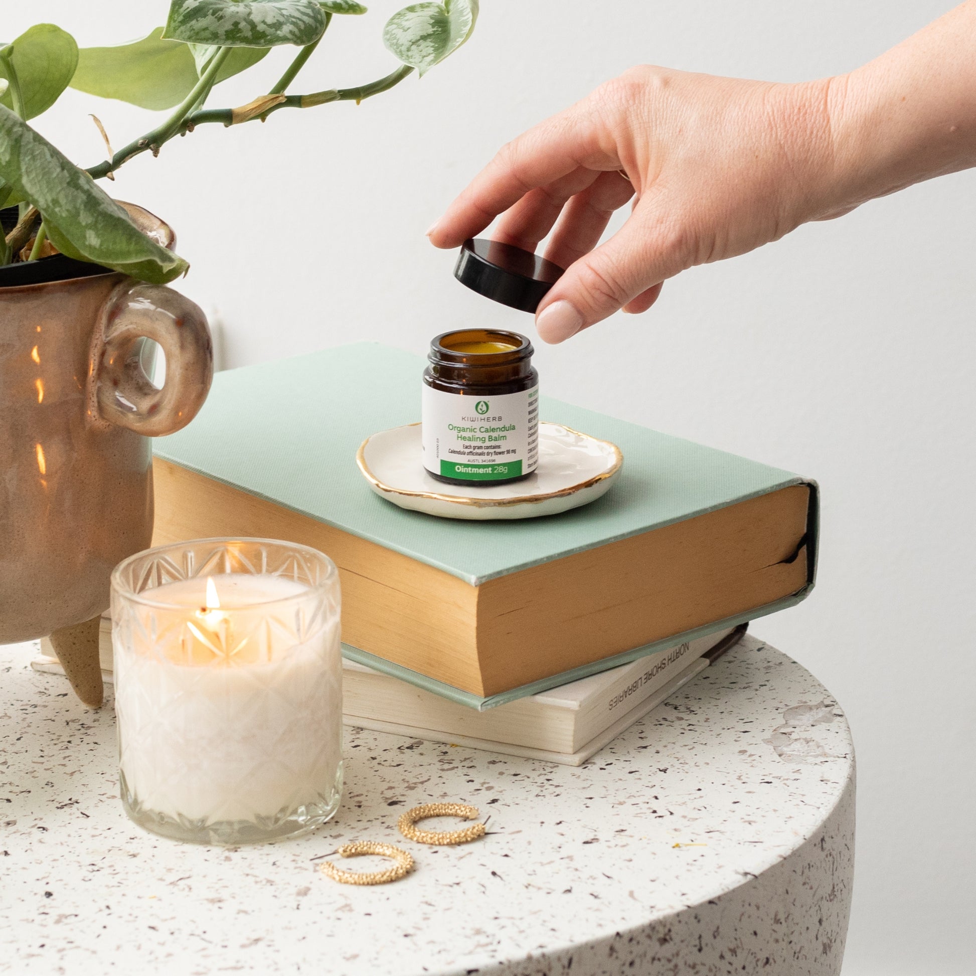 A jar of Organic Calendula Healing Balm on a table. Perfect for baby nappy rashes od healing minor wounds.