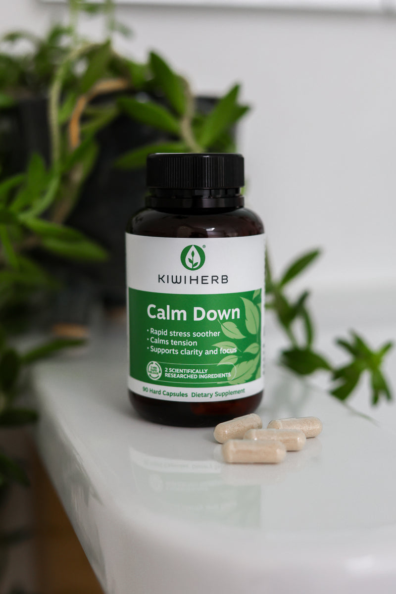 KiwiHerb Calm Down supplement bottle on a white surface with plants in the background