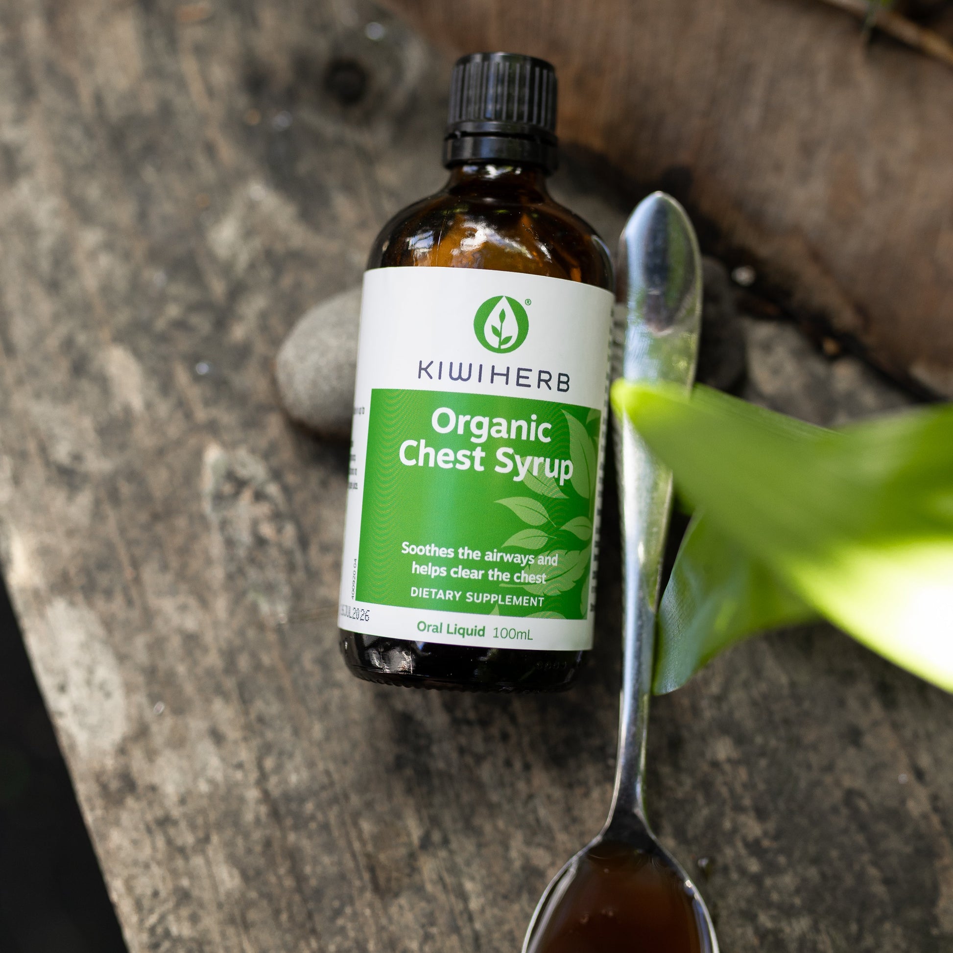 A bottle with a spoon of Organic Chest Syrup to support healthy lungs and airways. Helps to ease bronchial and chest tightness. 