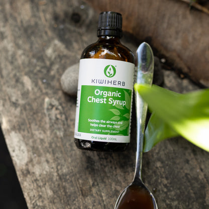A bottle with a spoon of Organic Chest Syrup to support healthy lungs and airways. Helps to ease bronchial and chest tightness. 