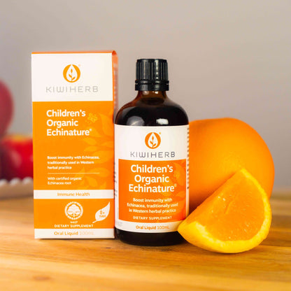 Children's Organic Echinature on a wooden slab with fresh oranges.